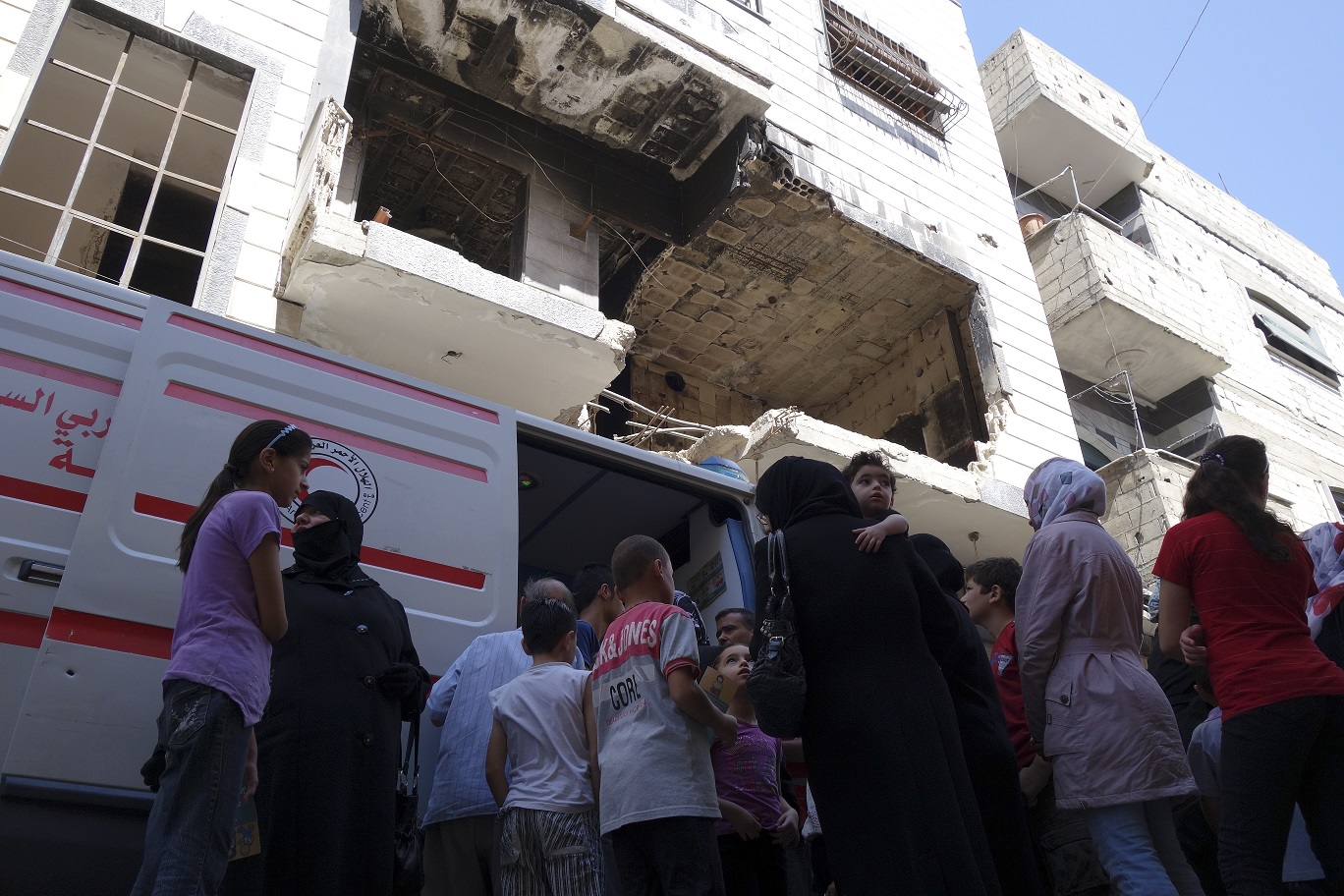 Rural Homs, Malaha village, Syria. ICRC supported Mobile Health Unit. Women and children queuing. Photo by Pawel Krzysiek/ICRC