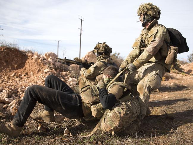 A New Zealand Army soldier drags a 'wounded' enemy soldier to safety during Exercise Hamel at Iron Knob, South Australia, last year.Defence.jpg