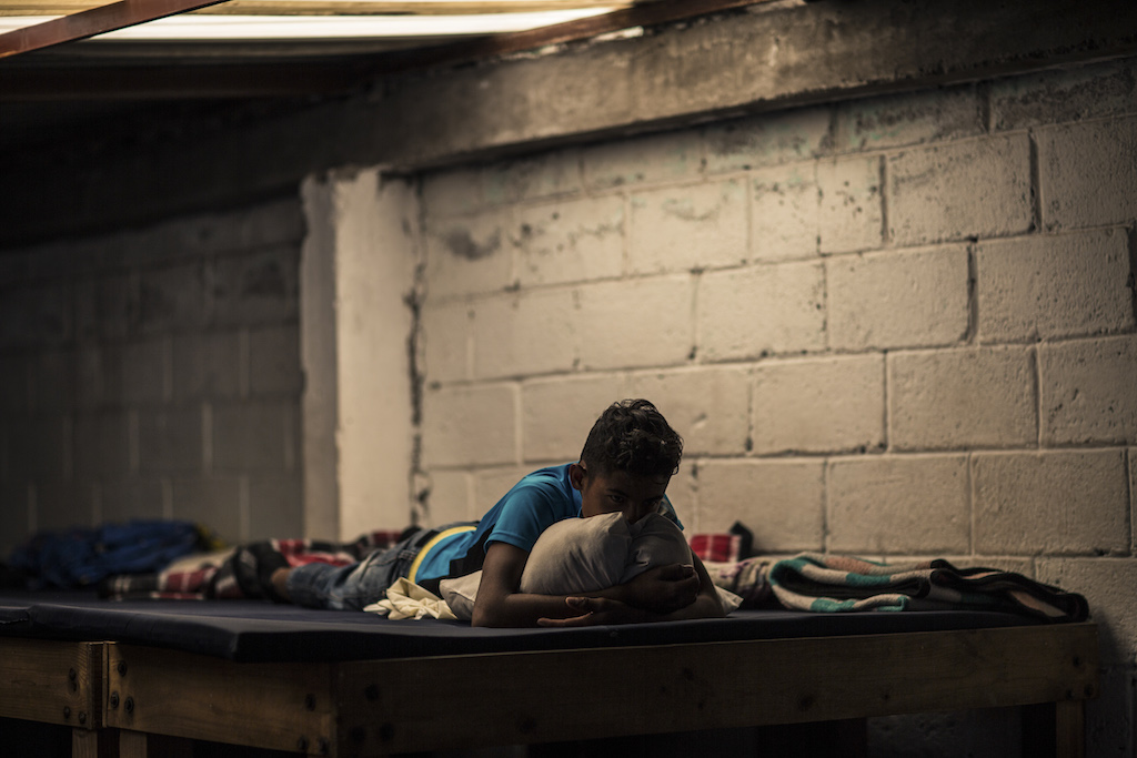 Tlaxcala State, Apizaco, migrant shelter. A young migrant is resting. ICRC/ Jesús Cornejo