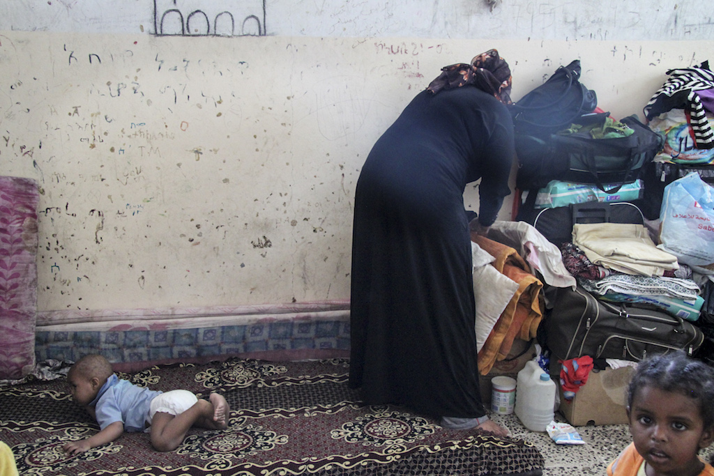 Sana'a, Passport Agency. An Ethiopian mother and her baby await to be deported back home.