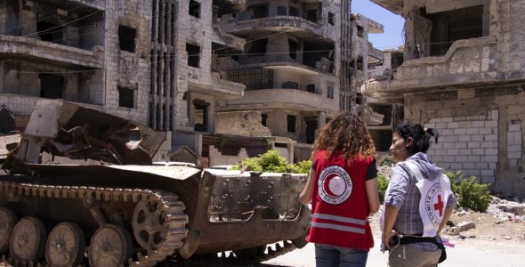 An ICRC weapons contamination specialist talks to a Syrian Arab Red Crescent staff member during an explosive ordnance disposal training session.