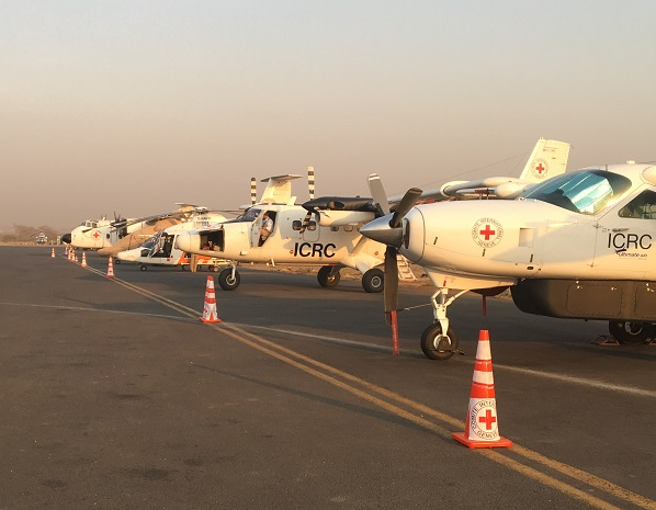 ICRC's aircraft at Juba Airport Depicting a Buffalo Aircraft (DHC-5 – cargo only), a helicopter (EC155B), a Twin Otter (DHC-6) and a Caravan (C208) for cargo. (ICRC/Laurent Camisa)