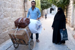 Old city, Aleppo, A man leavs his home with a few belongings in search of a safer place.