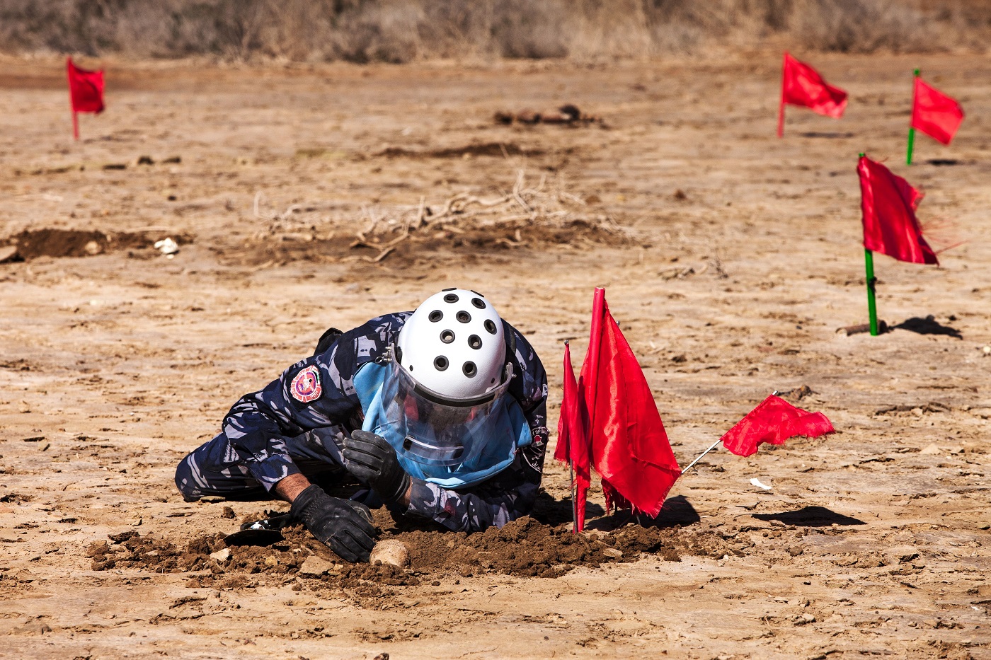 An Iraqi Civil Defense officer practices the clearing procedures of an area contaminated by anti-personnel landmines and explosive remnants of war.