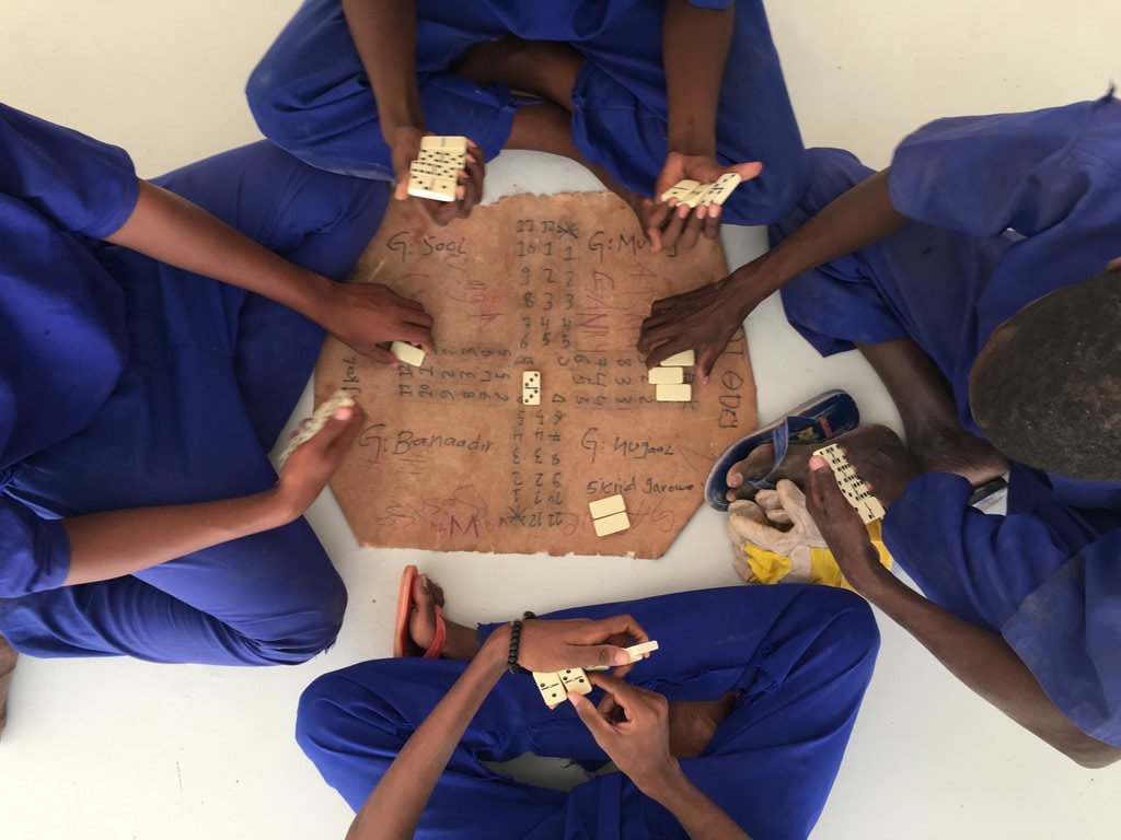 Board games, particularly dominoes, are a favourite amongst the inmates inside the prison. ©ICRC/Abdikarim Mohamed